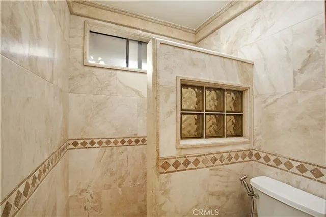 a bathroom with a window and a shower