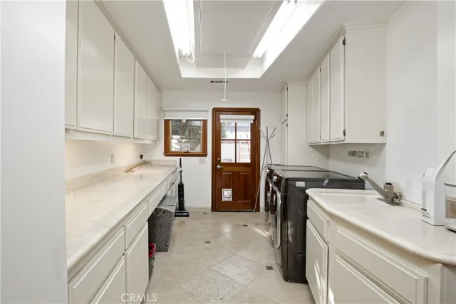 a utility room with a sink a washer and dryer