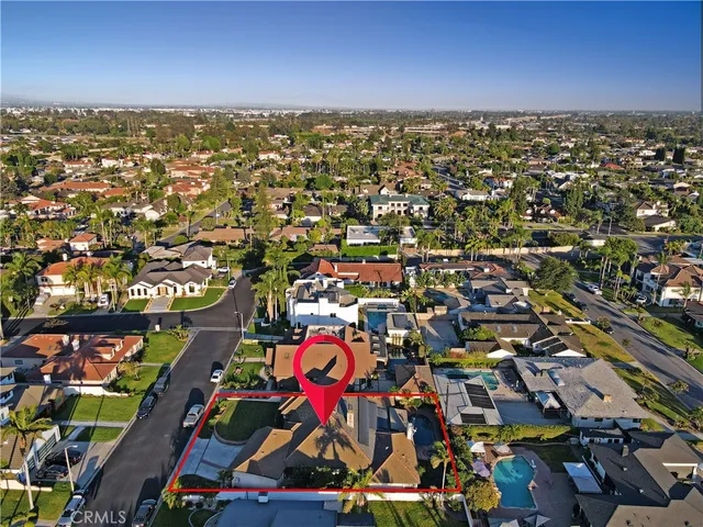an aerial view of residential houses with outdoor space and lake view