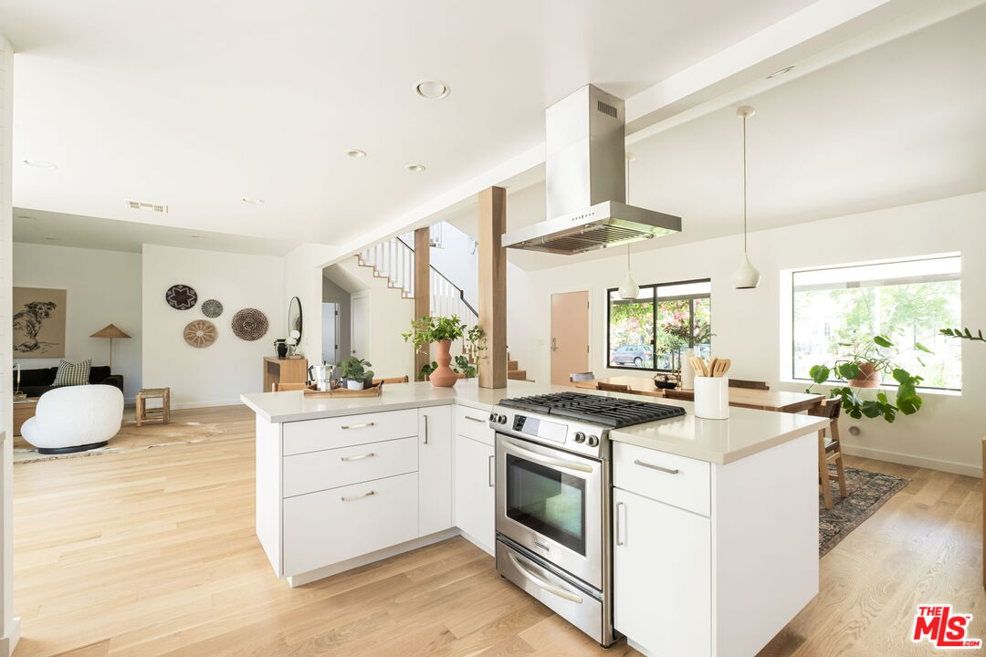 3414 Ferncroft Road Los Angeles, CA 90039 - Photo 11 of 47 a kitchen that has a lot of white cabinets and wooden floor