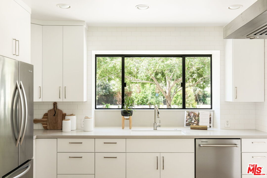 3414 Ferncroft Road Los Angeles, CA 90039 - Photo 12 of 47 a kitchen with stainless steel appliances a sink a large window and cabinets