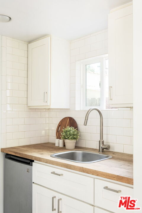 3414 Ferncroft Road Los Angeles, CA 90039 - Photo 37 of 47 a close view of a sink a faucet and a stove in a white kitchen