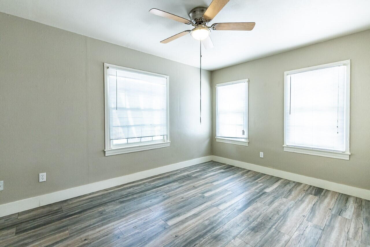 2311 25th Street Lubbock, TX 79411 - Photo 14 of 14 a view of an empty room with a window and wooden floor
