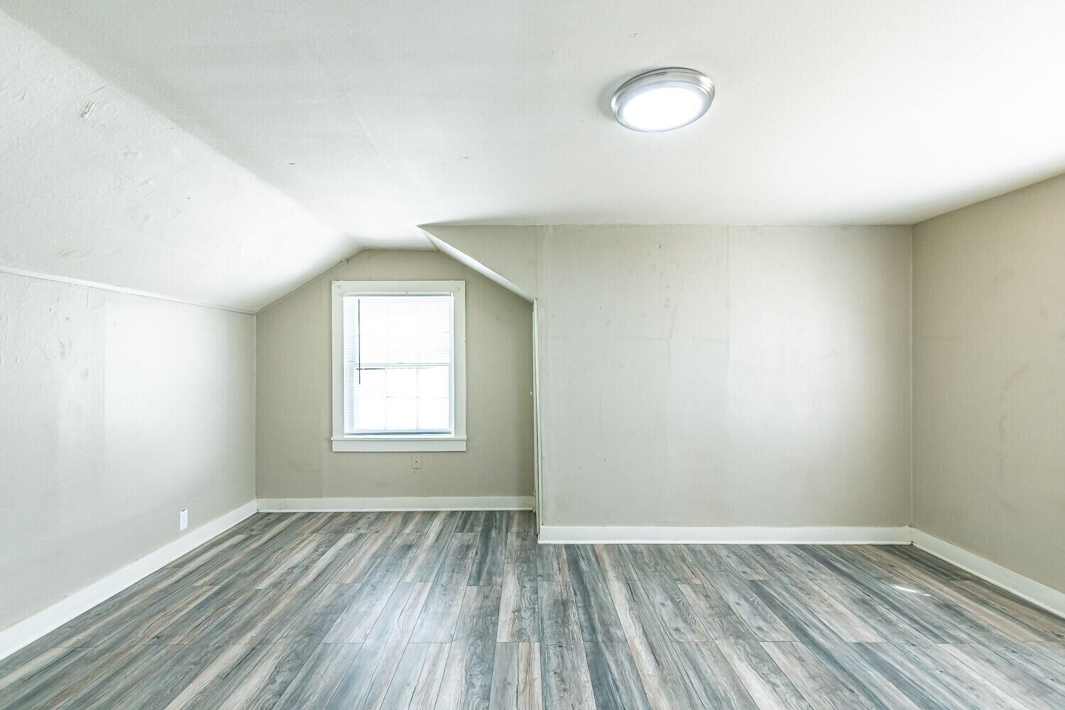 2311 25th Street Lubbock, TX 79411 - Photo 6 of 14 an empty room with wooden floor and windows