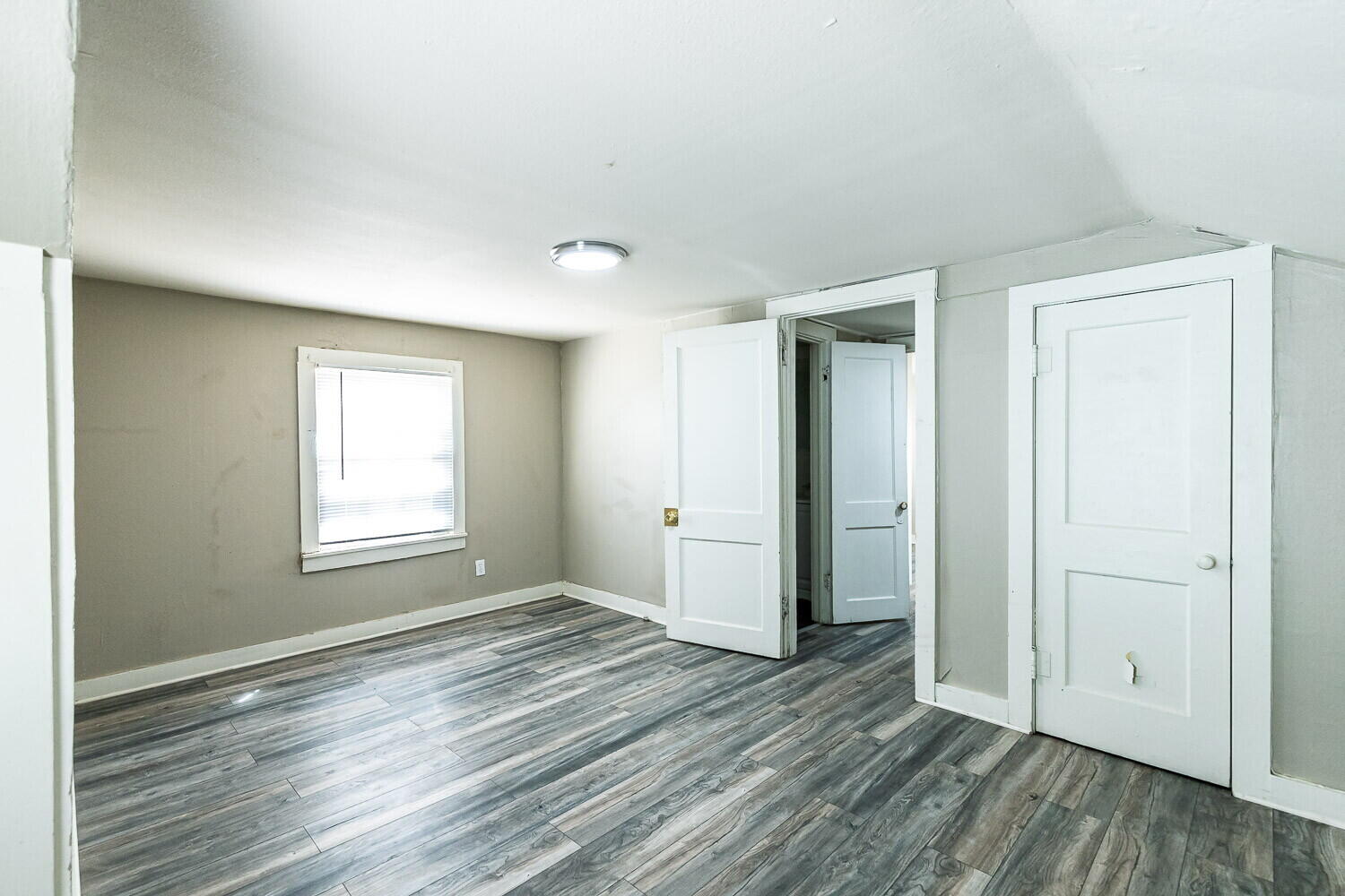 2311 25th Street Lubbock, TX 79411 - Photo 7 of 14 an empty room with wooden floor and windows