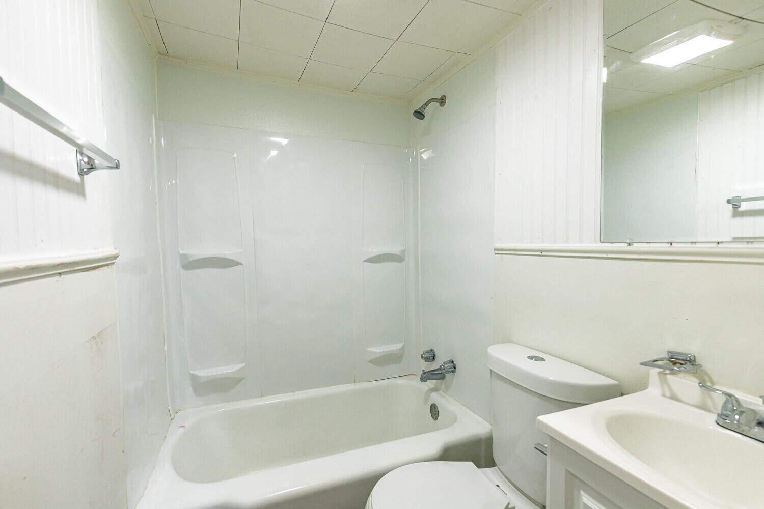 2311 25th Street Lubbock, TX 79411 - Photo 8 of 14 a white toilet sitting next to a bath tub