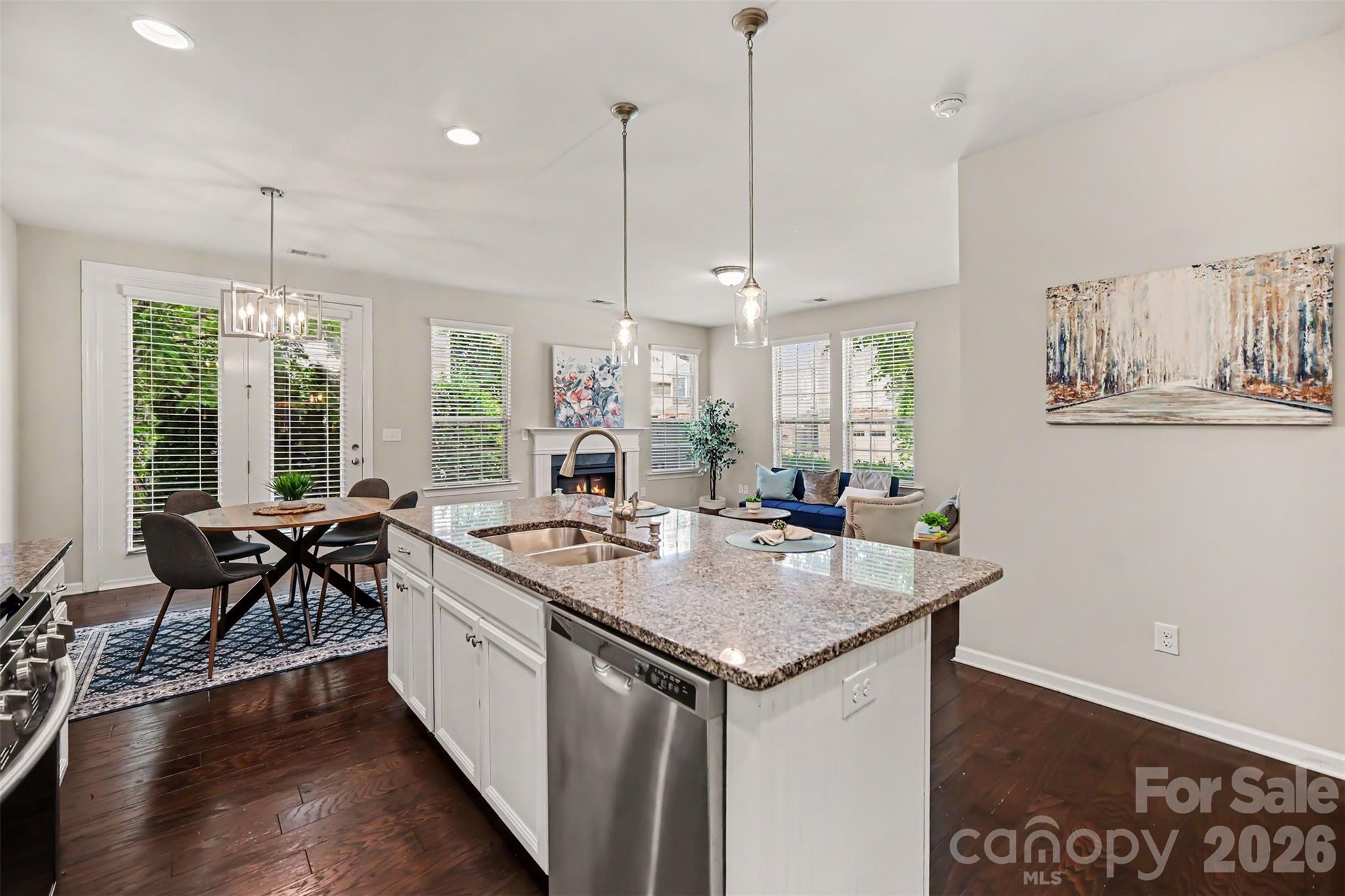 1029 Archibald Avenue Fort Mill, SC 29708 - Photo 11 of 45 a kitchen with stainless steel appliances granite countertop a stove a sink a kitchen island with furniture and wooden floor