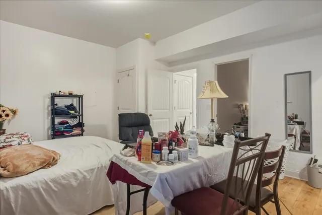 a view of a dining room with furniture and a potted plant