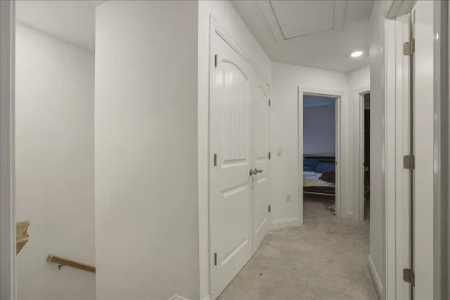 a view of a hallway with closet and bathroom