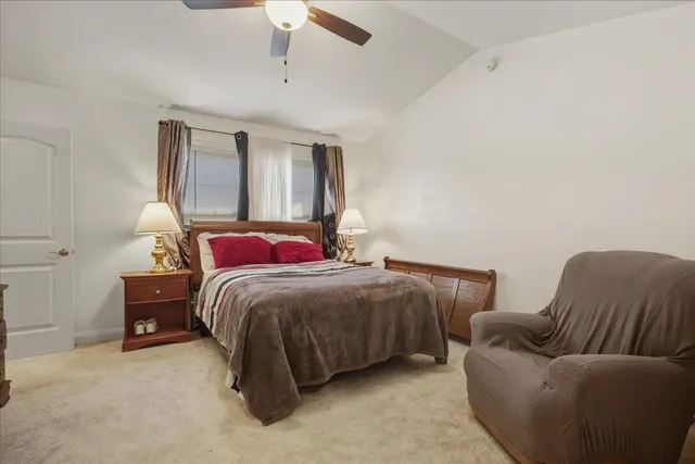 a bedroom with a bed couch and window