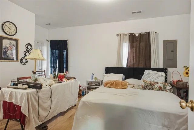 a bedroom with two beds and a chair