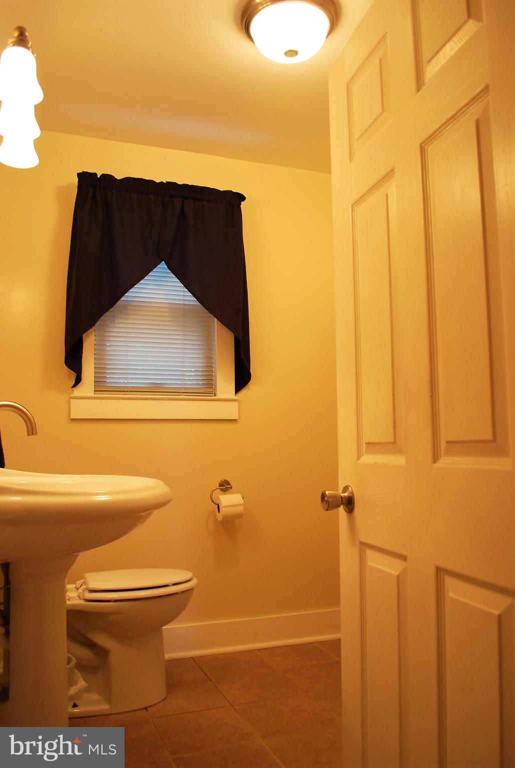 4333 Ridge Avenue Baltimore, MD 21227 - Photo 10 of 35 Main-level powder room w custom tile
