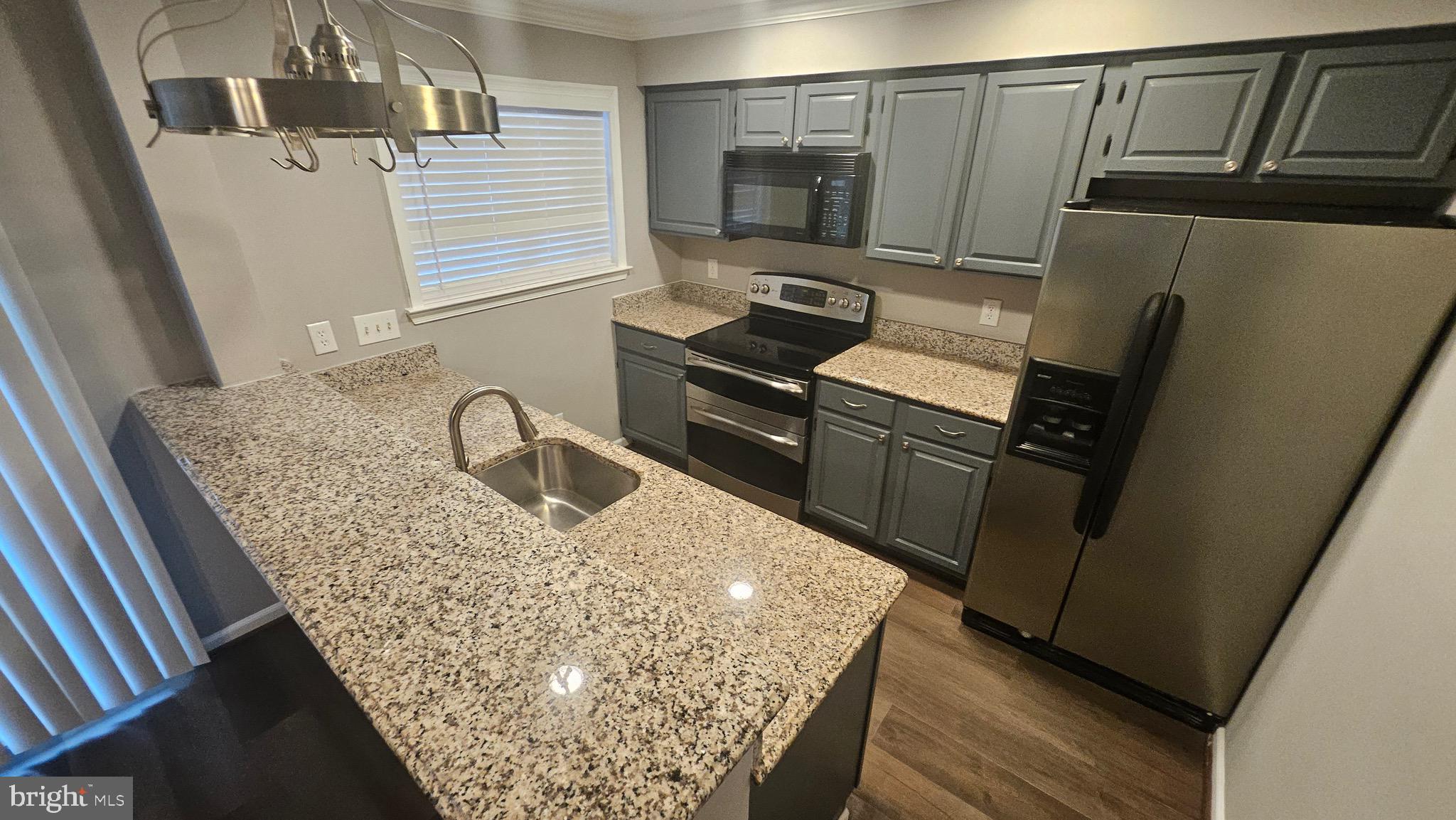 14224 Jib Street, Unit 6142 Laurel, MD 20707 - Photo 8 of 15 a kitchen with a sink stove and refrigerator
