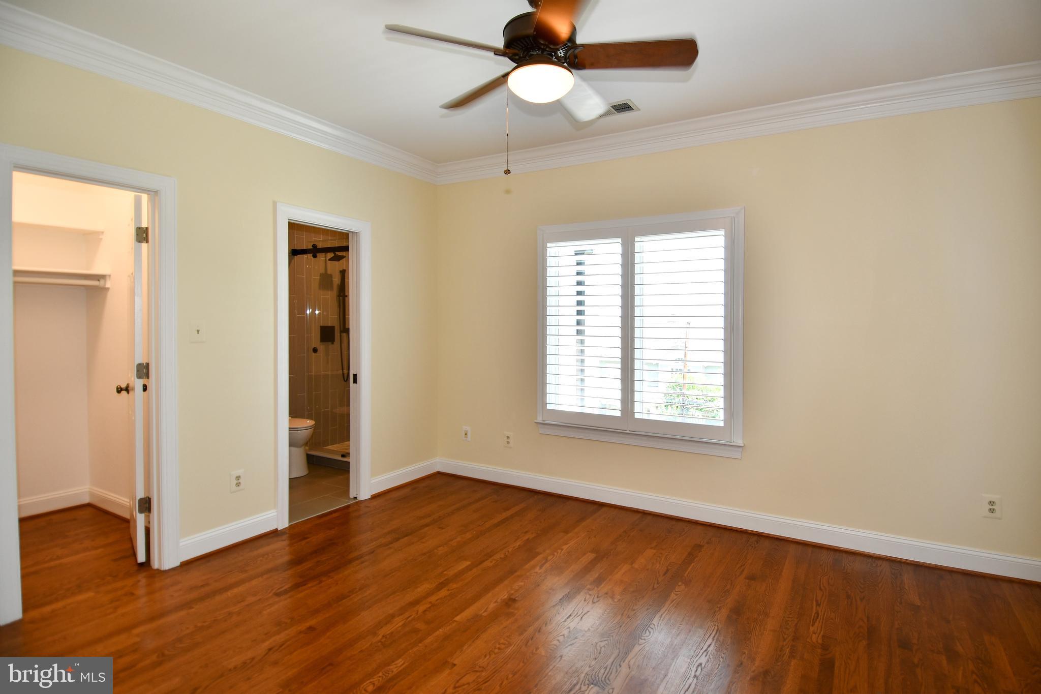 7808 Southdown Road Alexandria, VA 22308 - Photo 73 of 99 a view of an empty room with wooden floor and a window