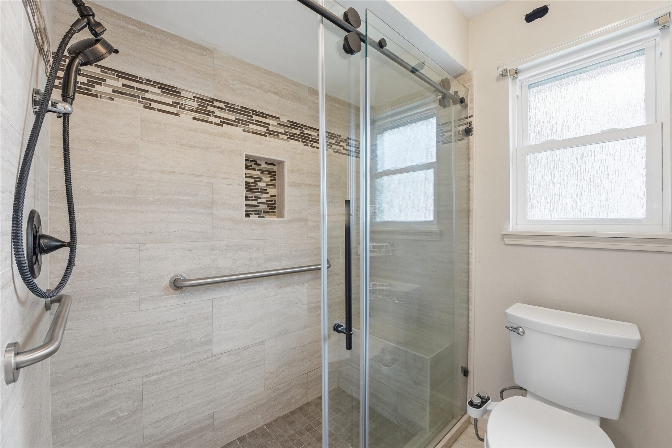 8115 Theisswood Road Spring, TX 77379 - Photo 21 of 36 a bathroom with a toilet and a shower