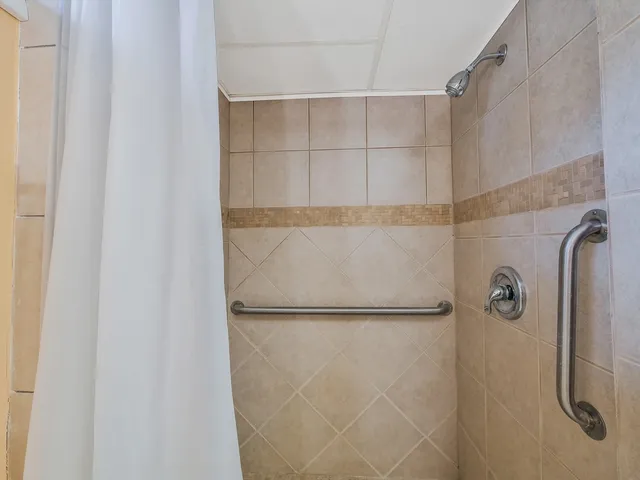 a bathroom with a glass shower door