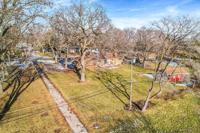 an aerial view of residential houses with yard
