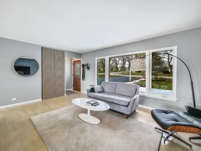 a living room with furniture and a floor to ceiling window