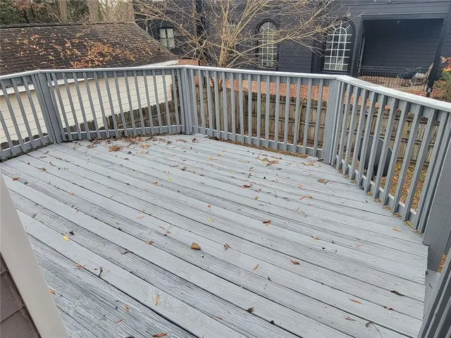 a view of a wooden deck and a backyard