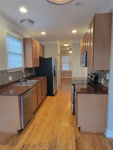 a stove top oven sitting inside of a kitchen