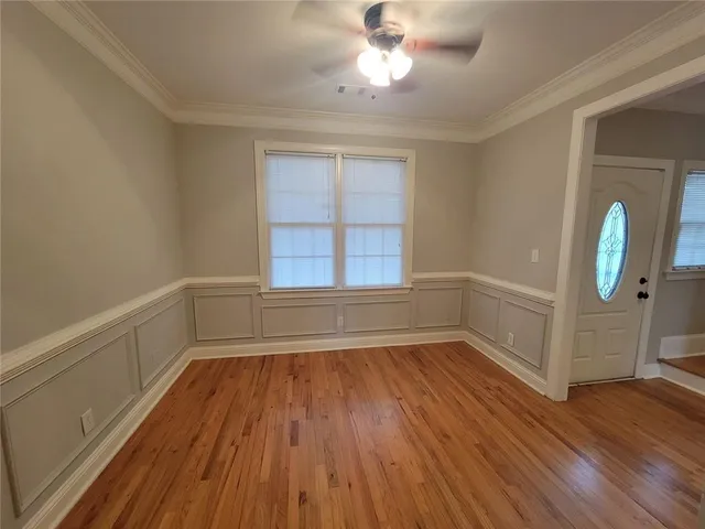 a view of a room with wooden floor and window