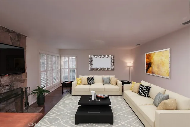 a kitchen with stainless steel appliances kitchen island granite countertop a stove a refrigerator a sink a oven and a dining table with wooden floor