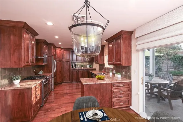 a kitchen with a refrigerator and a stove top oven