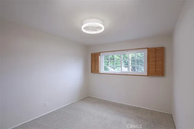 a bathroom with a granite countertop sink toilet a mirror and shower