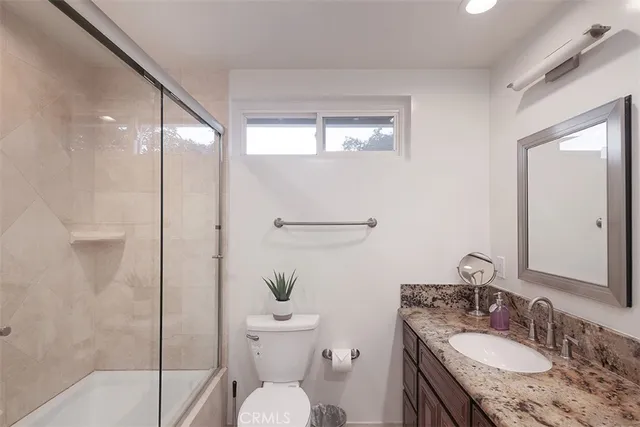 a view of a chair and table in backyard of the house