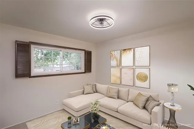 an aerial view of a city with lots of residential buildings green landscape and mountain view