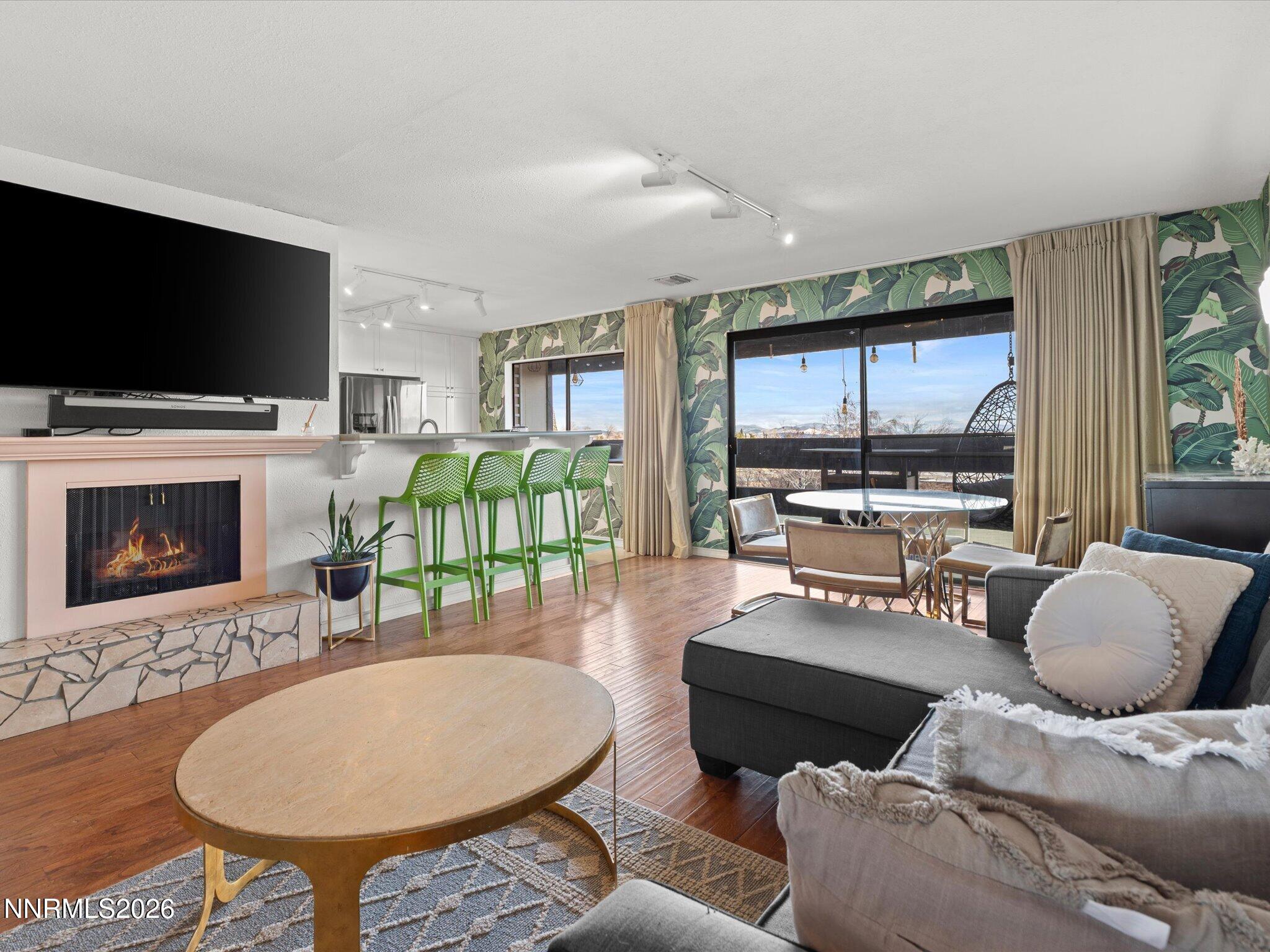 3149 Cashill Boulevard Reno, NV 89509 - Photo 15 of 44 a living room with furniture a flat screen tv and a fireplace