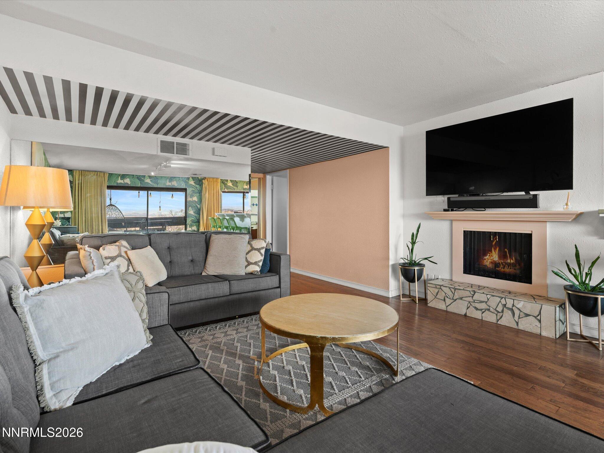 3149 Cashill Boulevard Reno, NV 89509 - Photo 16 of 44 a living room with furniture a flat screen tv and a fireplace