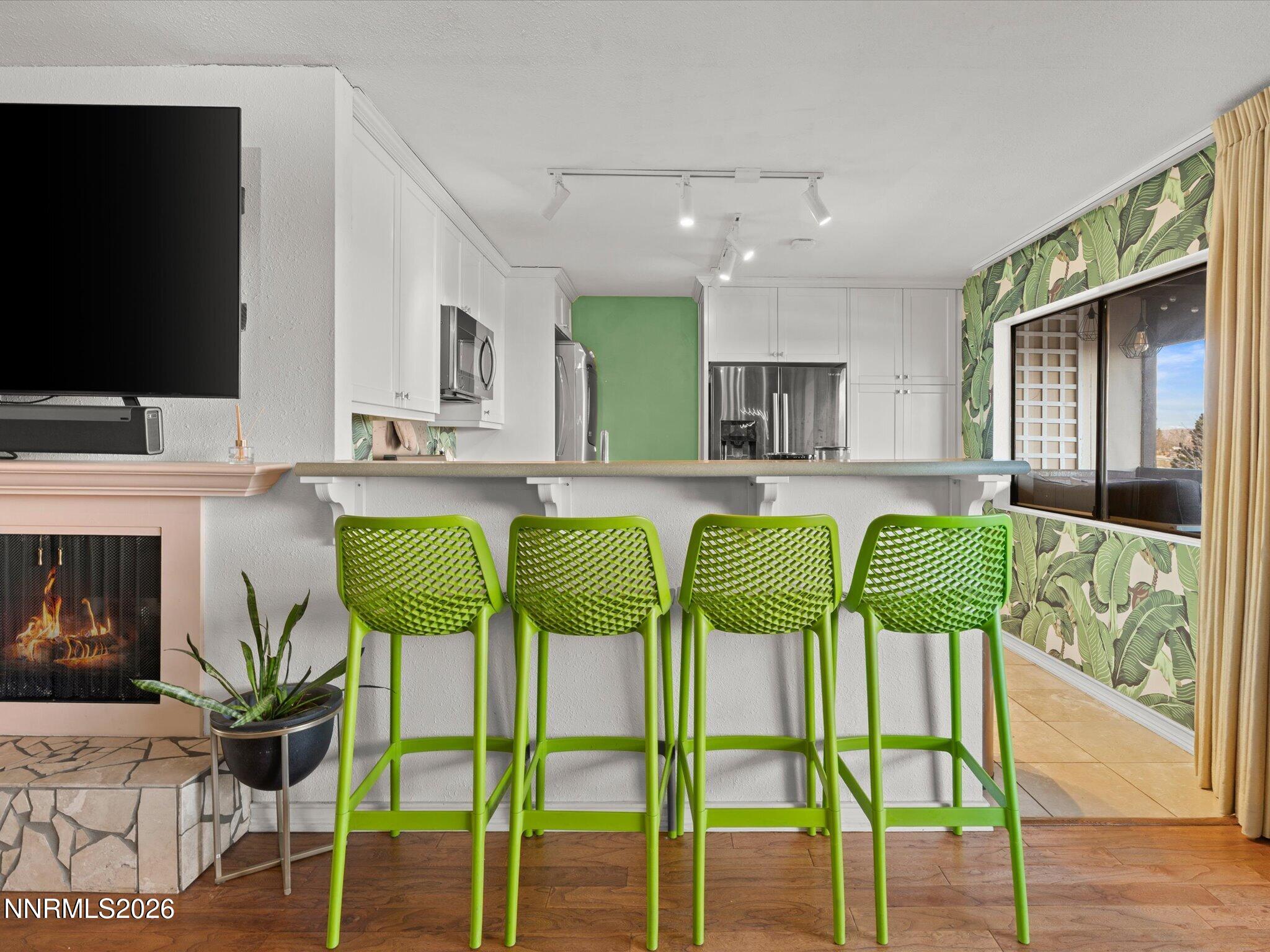 3149 Cashill Boulevard Reno, NV 89509 - Photo 21 of 44 a kitchen with a table chairs refrigerator and microwave
