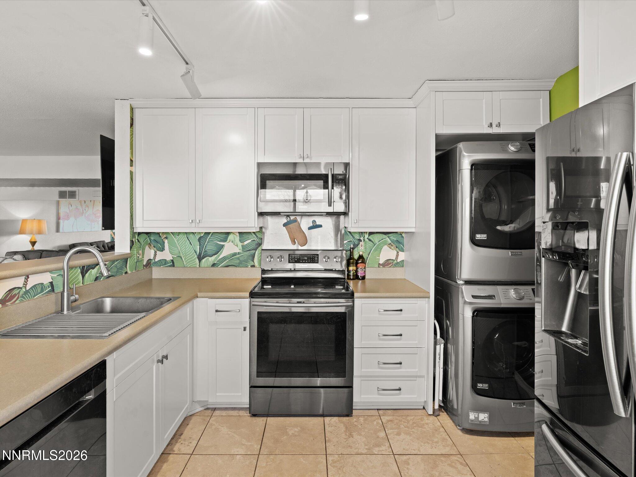 3149 Cashill Boulevard Reno, NV 89509 - Photo 23 of 44 a kitchen with cabinets stainless steel appliances and a counter space
