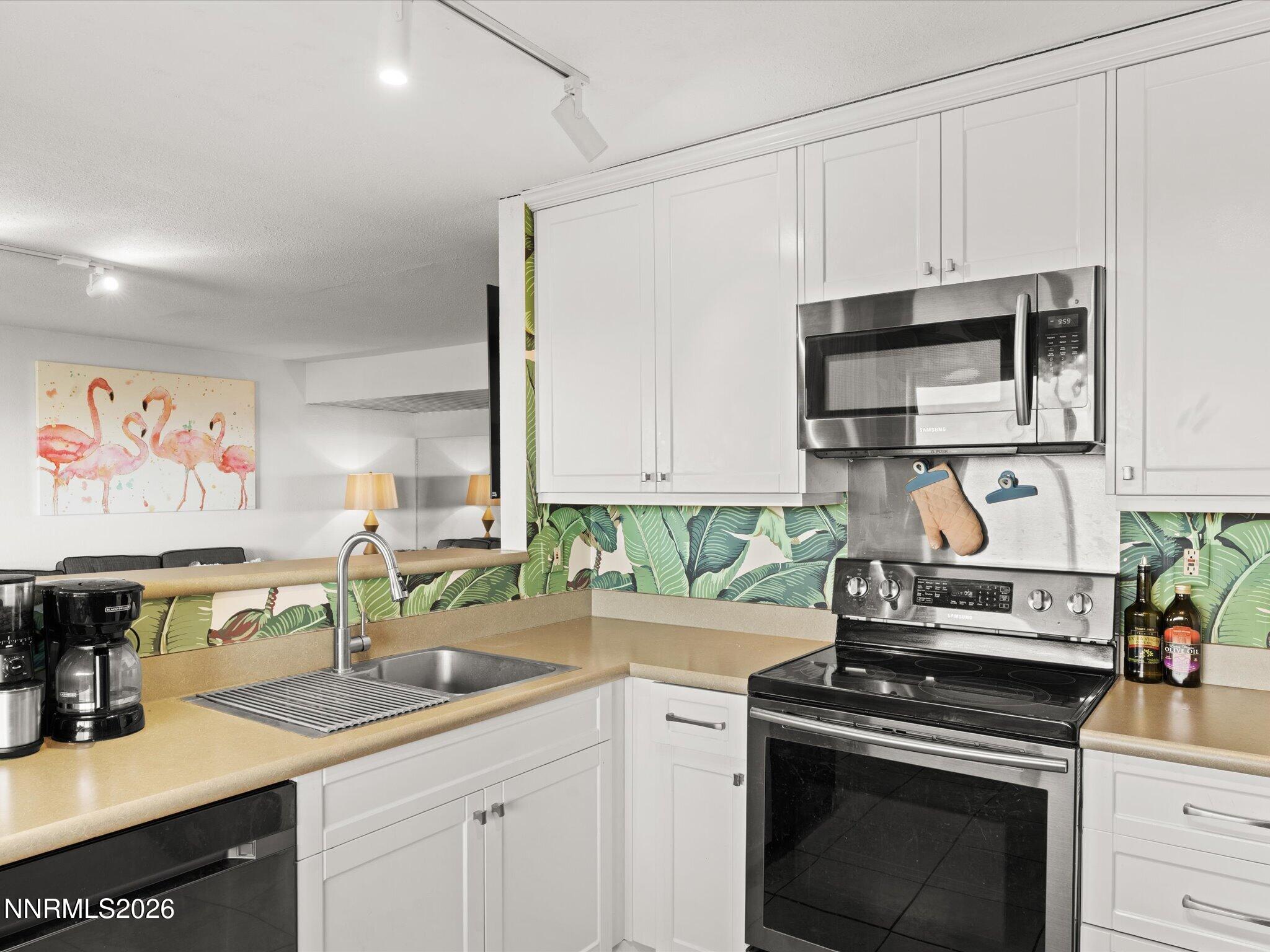 3149 Cashill Boulevard Reno, NV 89509 - Photo 24 of 44 a kitchen with stainless steel appliances a stove a sink and a microwave