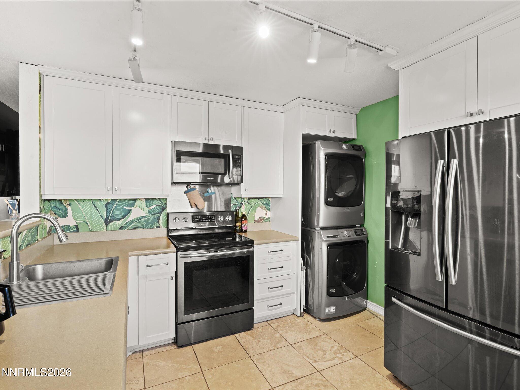 3149 Cashill Boulevard Reno, NV 89509 - Photo 26 of 44 a kitchen with stainless steel appliances granite countertop a refrigerator stove and sink