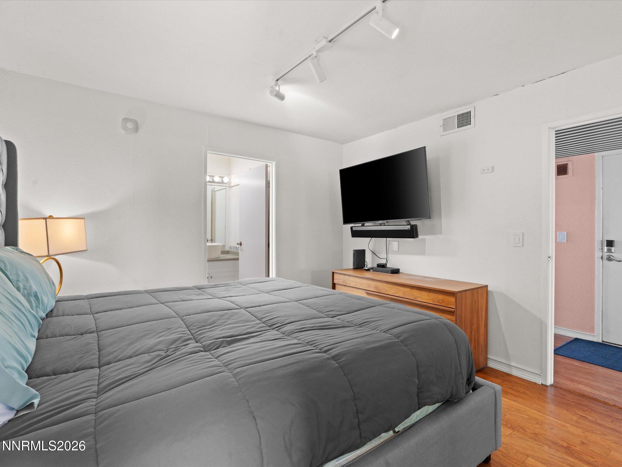 3149 Cashill Boulevard Reno, NV 89509 - Photo 30 of 44 a bedroom with a bed and a flat screen tv