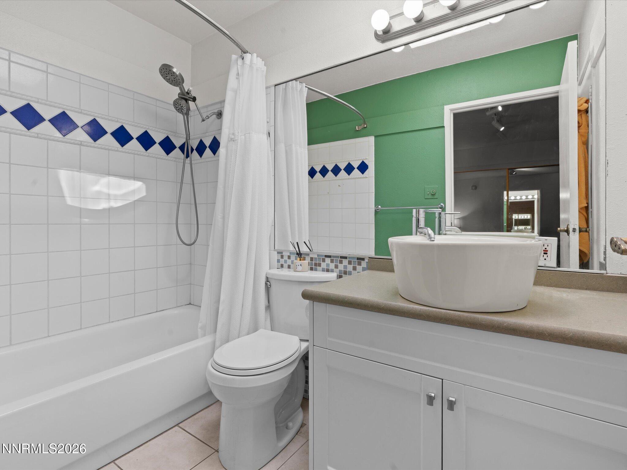 3149 Cashill Boulevard Reno, NV 89509 - Photo 31 of 44 a bathroom with a granite countertop bathtub sink vanity mirror and toilet