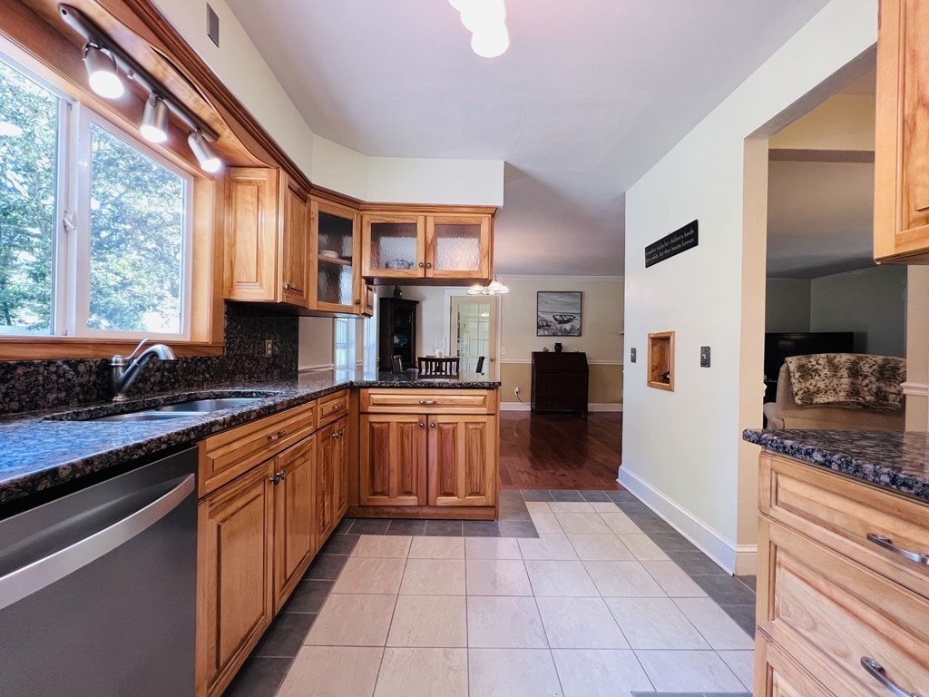 3 Windmill Road Bourne, MA 02532 - Photo 12 of 42 a large kitchen with stainless steel appliances granite countertop a large stove a sink dishwasher and cabinets with wooden floor