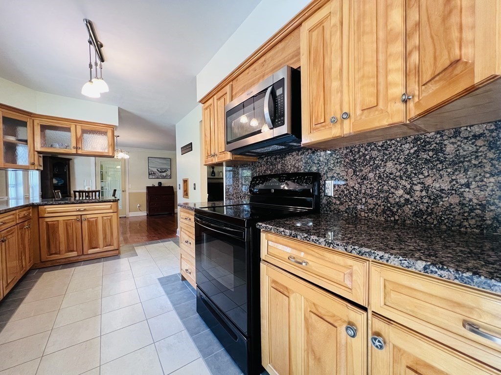 3 Windmill Road Bourne, MA 02532 - Photo 13 of 42 a kitchen with stainless steel appliances granite countertop a stove a sink and a microwave