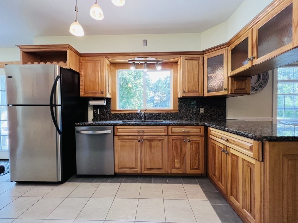 3 Windmill Road Bourne, MA 02532 - Photo 14 of 42 a kitchen with stainless steel appliances granite countertop a refrigerator sink and cabinets