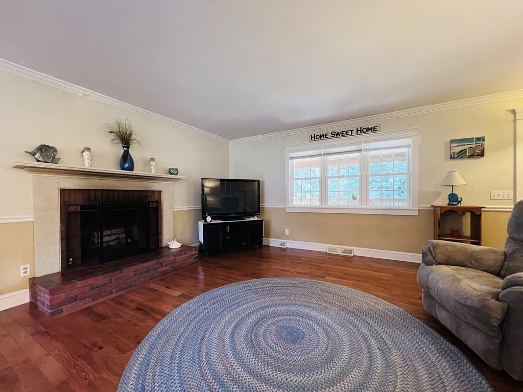 3 Windmill Road Bourne, MA 02532 - Photo 20 of 42 a living room with furniture and a fireplace