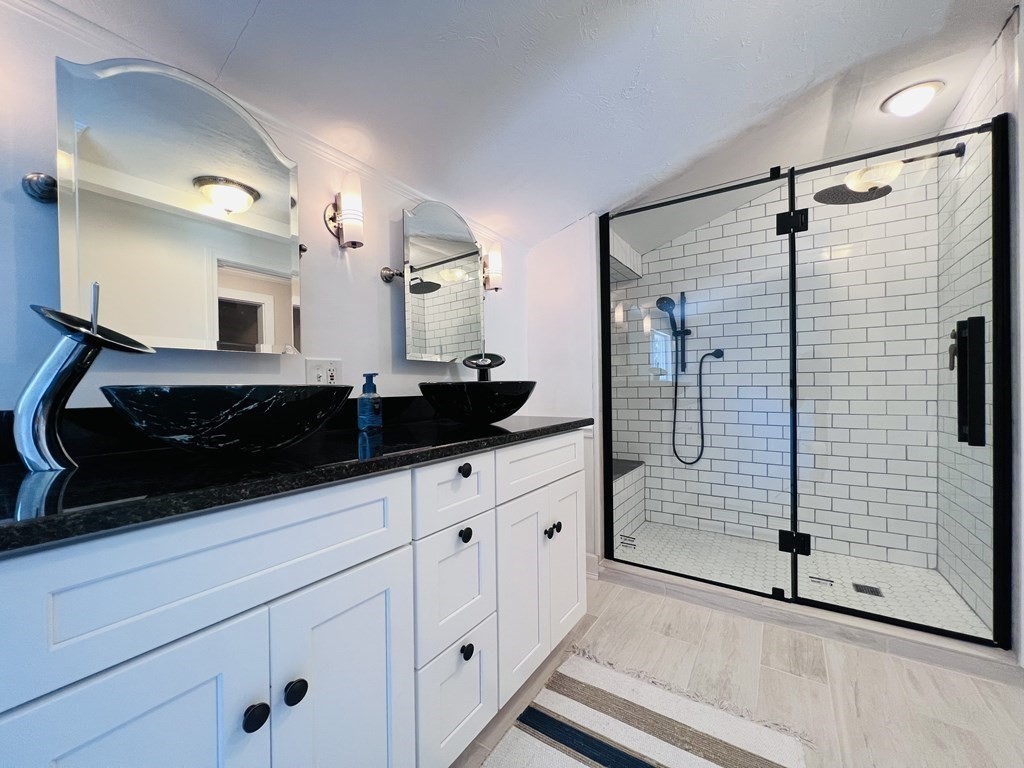 3 Windmill Road Bourne, MA 02532 - Photo 28 of 42 a bathroom with a double vanity sink a mirror and shower