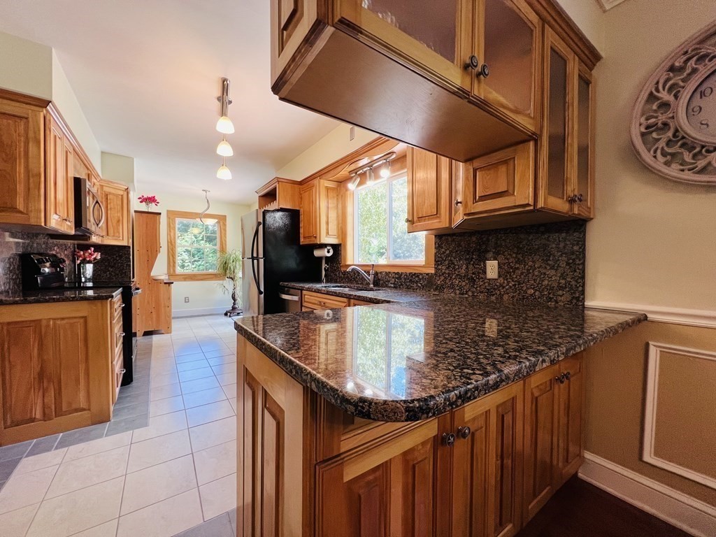3 Windmill Road Bourne, MA 02532 - Photo 10 of 42 a kitchen with stainless steel appliances granite countertop a sink a stove and a refrigerator