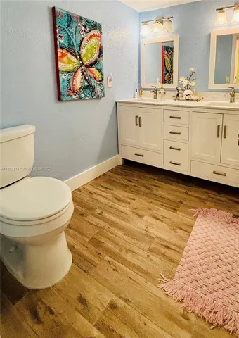 a spacious bathroom with a double vanity sink a mirror and a bathtub