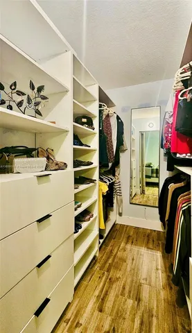 a bedroom with a bed and a view of wooden floor