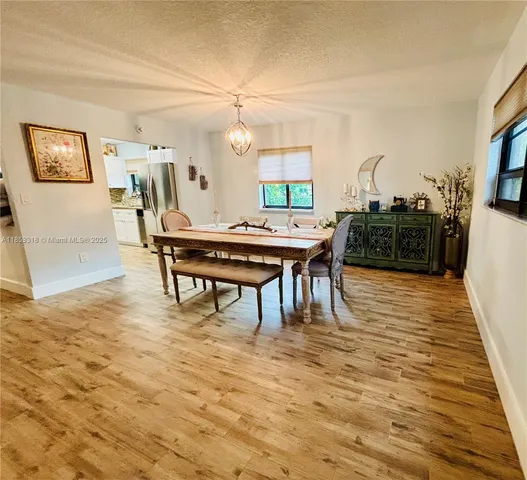 a dining room with furniture and wooden floor