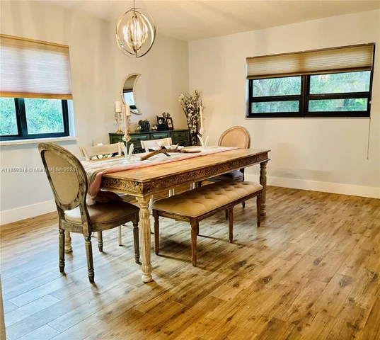 a view of a dining room with furniture and a window