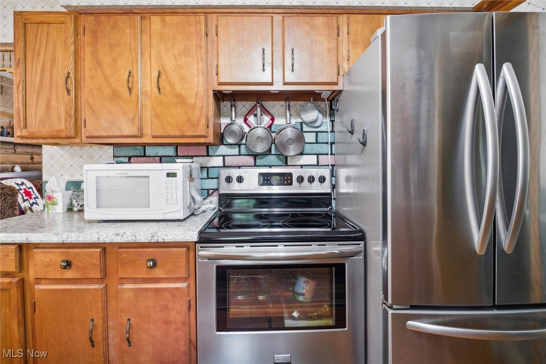 2820 Adams Road Kingsville, OH 44048 - Photo 24 of 34 Kitchen featuring backsplash and stainless steel appliances
