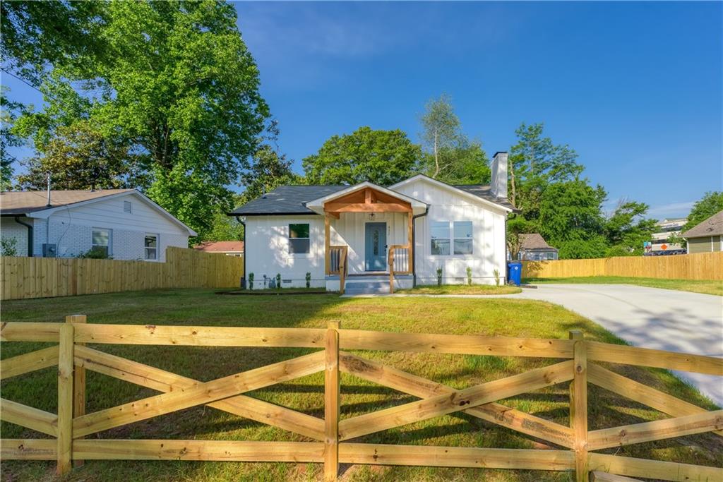 a view of a house with swimming pool and a yard